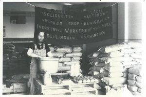 Preparing food for a Food For People dinner at the old Fairhaven Cooperative Flour Mill. Note the IWW banner. 1982